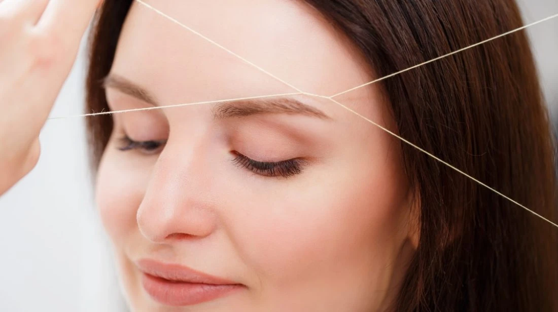 Professional forehead and eyebrow threading procedure at Brooklyn Brows