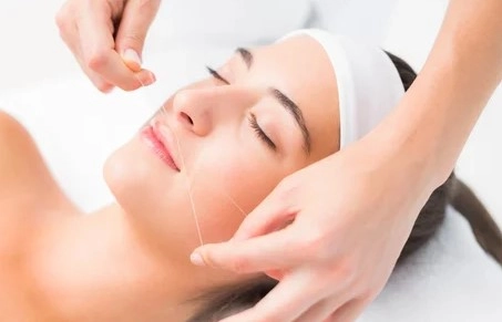 Precise upper lip threading hair removal treatment in progress
