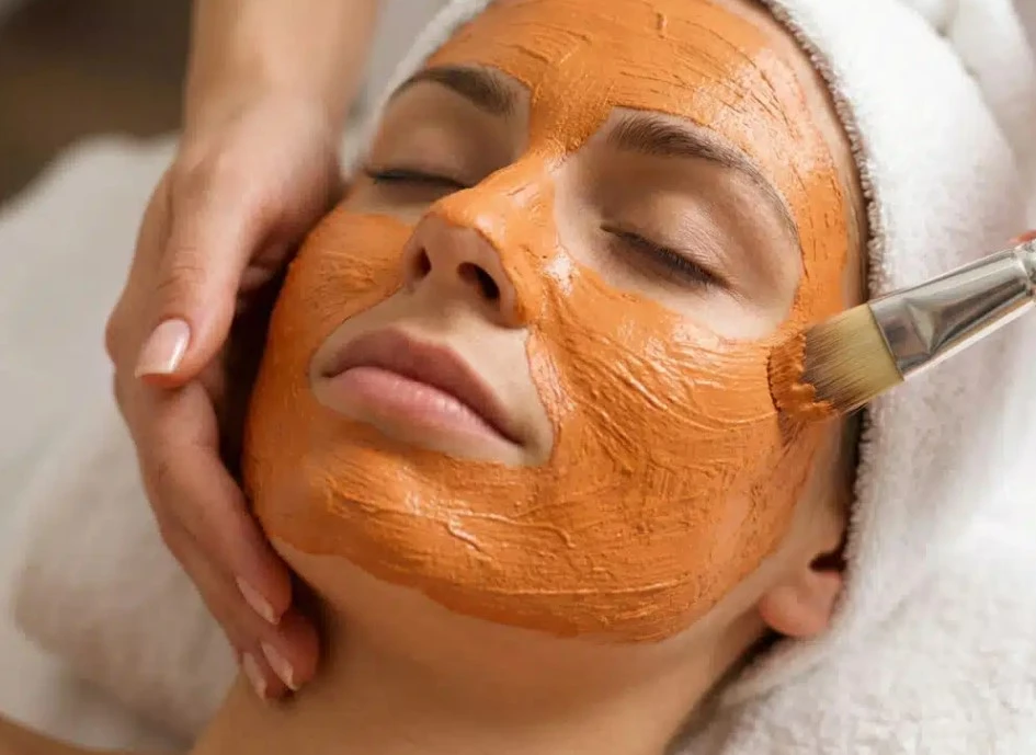 Applying an organic clay facial mask using a professional applicator brush